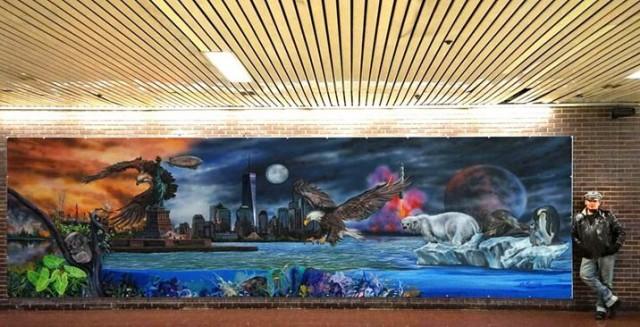 Maristela stands beside his &acirc;One Habitat&acirc; mural displayed at the Port Authority Bus Terminal in Times Square. Courtesy: The FilAm