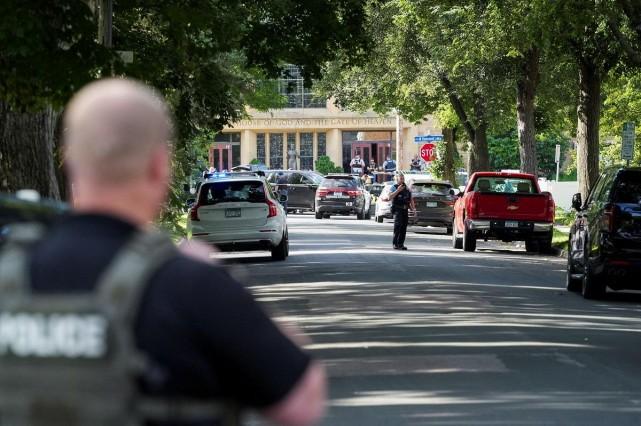 Law enforcement officers gather outside Annunciation Church following a mass shooting event, in Minneapolis, Minnesota, August 27, 2025. REUTERS/ Tim Evans