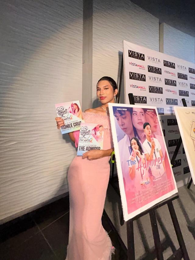 Prism poses with the poster for The Admirer, which they directed, at the Cinematic Bataan event.