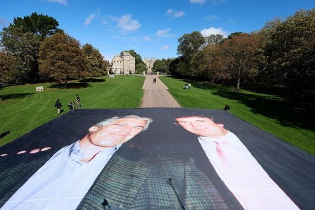 A large banner depicting US President Donald Trump alongside disgraced financier Jeffrey Epstein is displayed near the Windsor Castle by campaign group Everybody Hates Elon, protesting Trump's state visit to the country, in Windsor, Britain, September 15, 2025. REUTERS/ Hannah McKay
