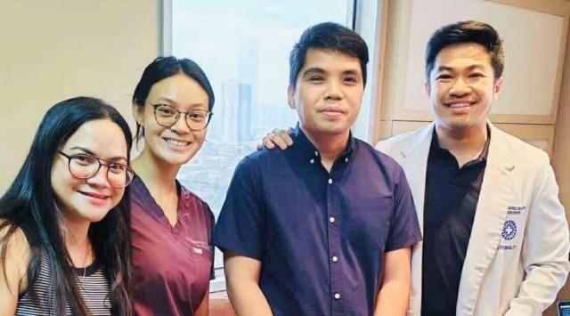 John Muni (third from left) during his visit with Dr. Jerold Justo (far right) three weeks after his surgery.