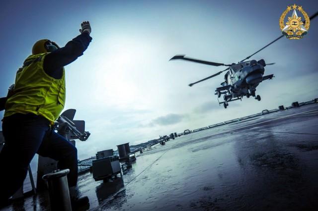 Philippine Navy personnel guides an AW159 helicopter as it lands on the flight deck of the BRP Jose Rizal (FF150) for the 10th Multilateral Maritime Cooperative Activity (MMCA). SSg Ambay PA / PAOAFP