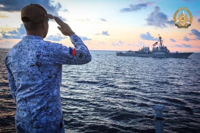  Upholding naval tradition, BRP Jose Rizal (FF150) personnel render a salute to U.S. counterparts as both ships sail in formation during the passing exercise. Photo by SSg Amagan PA / PAOAFP