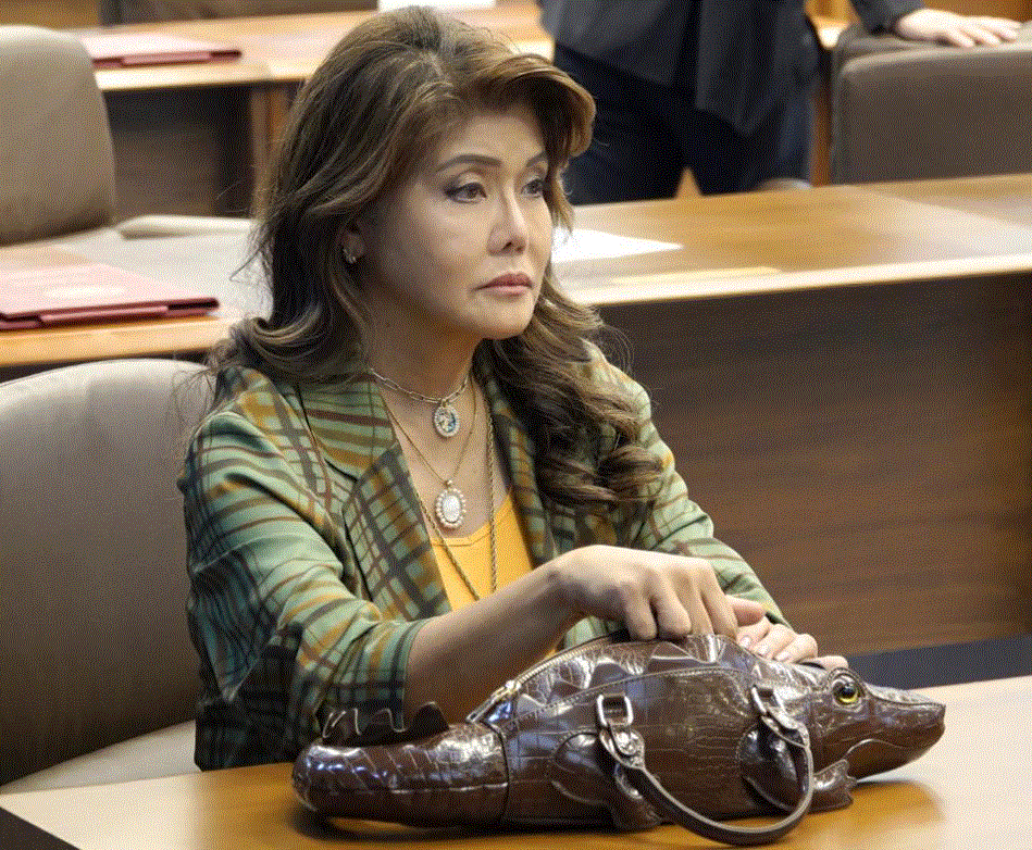 Does it have a name? Imee Marcos carries a crocodile-shaped bag to session
