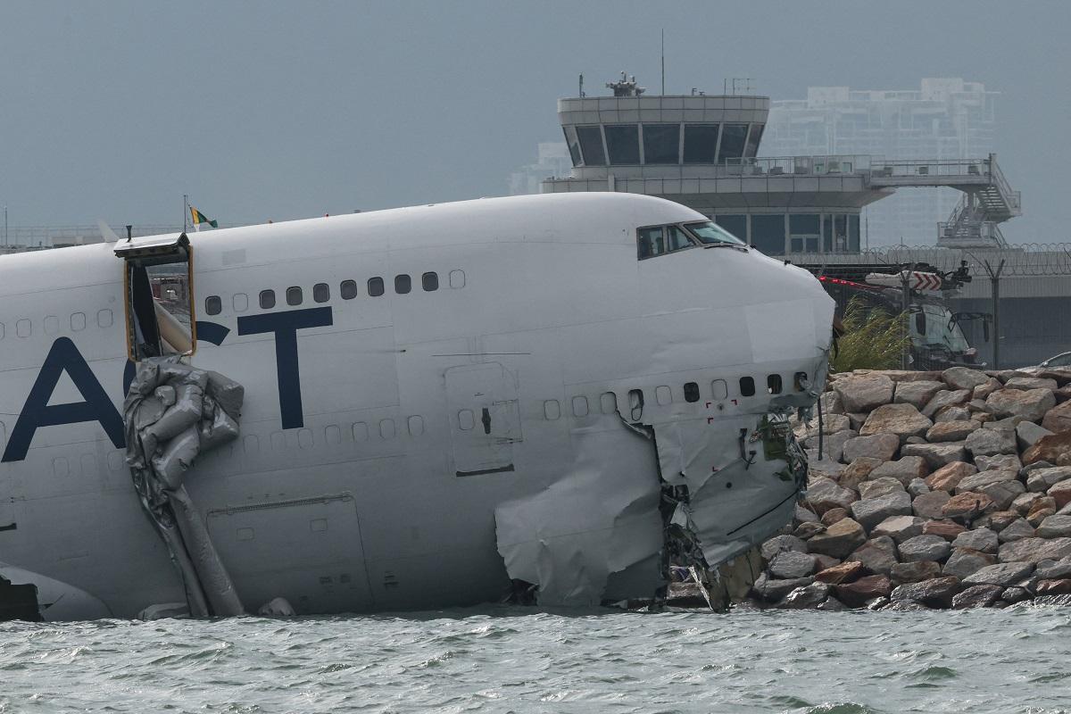 Cargo plane slides off runway in Hong Kong, killing two airport staff
