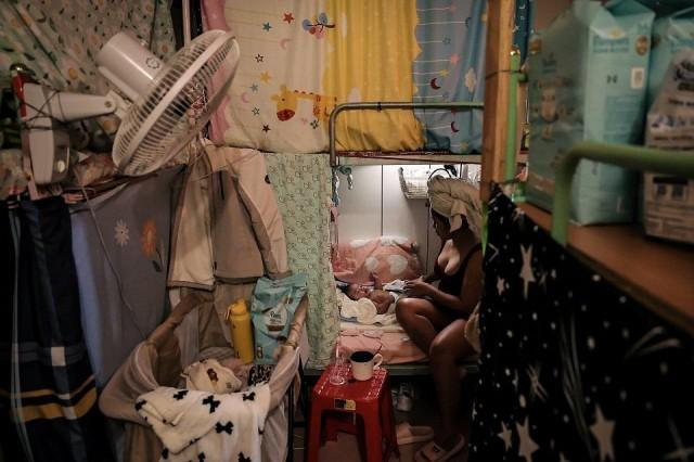 Marian Duhapa dresses her 3-month-old baby Quinn after giving her a bath in the shared bathroom at the migrant shelter where they lived before and after Marian's pregnancy, in New Taipei City, Taiwan, November 18, 2024. REUTERS/ Ann Wang
