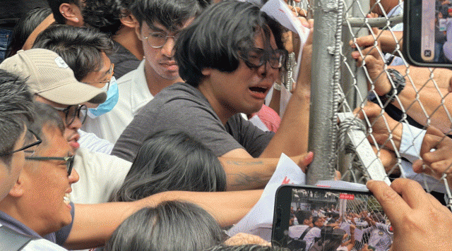 Protesters demanding accountability in the flood control projects scam storm the Department of Energy Compound in Taguig where the ICI is conducting its hearings (Photo by Joseph Morong/GMA Integrated News)