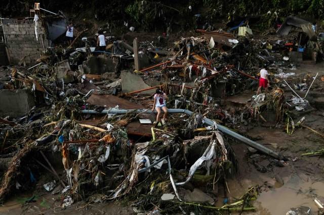 A drone view of a woman sitting on a fallen post amid the damage caused by Typhoon Tino (Kalmaegi) in Talisay, Cebu. November 5, 2025. REUTERS/Eloisa Lopez