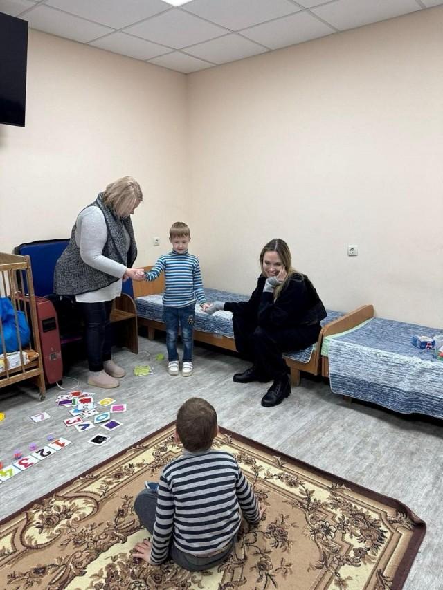 Angelina Jolie smiles as children play, amid Russia's attack on Ukraine, in Kherson, Ukraine, in this handout image released on November 6, 2025. Legacy of War Foundation/ Handout via REUTERS