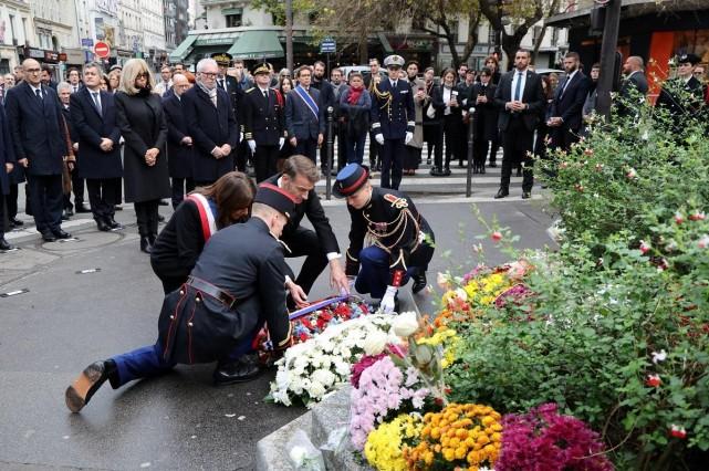France's President Emmanuel Macron and Paris Mayor Anne Hidalgo lay a wreath to pay tribute to victims at the intersection of Faubourg du Temple and Boulevard Jules Ferry near La Bonne Biere cafe in Paris on November 13, 2025, during ceremonies across Paris marking a decade since the attacks of November 13, 2015 in which 130 civilians were killed. Ludovic Marin/ Pool via REUTERS