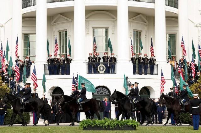 US President Donald Trump observes a procession of horses passing the White House ahead of the arrival of Saudi Crown Prince and Prime Minister Mohammed bin Salman, in Washington, D.C., November 18, 2025. REUTERS/ Kevin Lamarque 