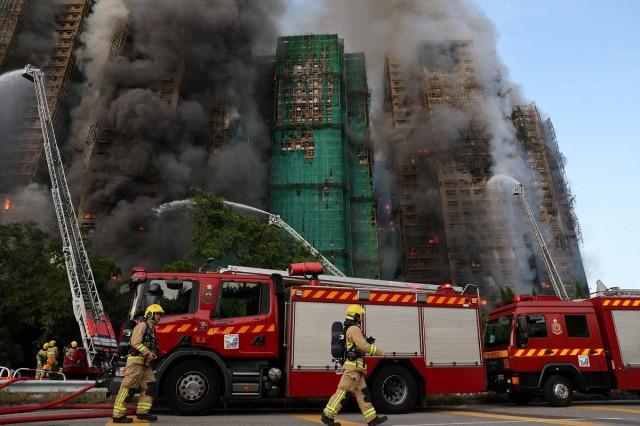 Firefighters work as efforts are underway to extinguish flames engulfing bamboo scaffolding across multiple buildings at the Wang Fuk Court housing estate in Tai Po, Hong Kong, China, November 26, 2025. REUTERS/ Tyrone Siu