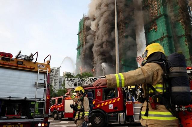 Firefighters work as efforts are underway to extinguish flames engulfing bamboo scaffolding across multiple buildings at the Wang Fuk Court housing estate in Tai Po, Hong Kong, China, November 26, 2025. REUTERS/Tyrone Siu