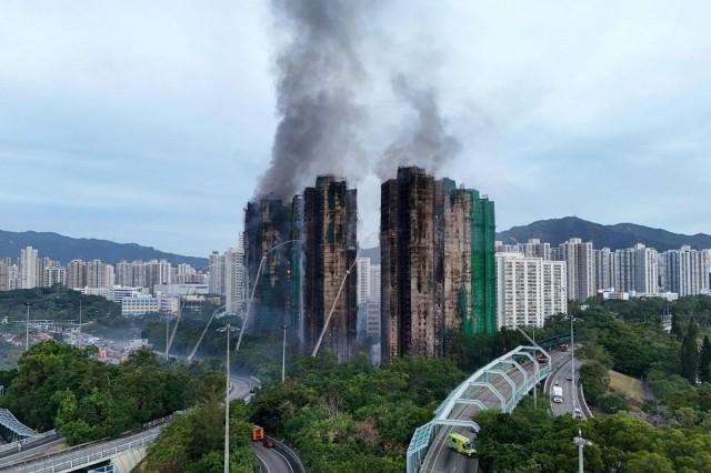 A drone view shows flames and thick smoke rising from the Wang Fuk Court housing estate during a major fire, in Tai Po, Hong Kong, China, November 27, 2025. REUTERS/ Tyrone Siu