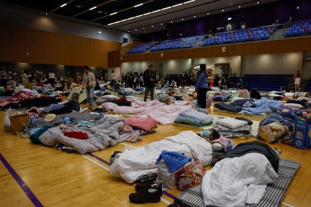 People shelter at an evacuation center, after a deadly fire broke out yesterday at Wang Fuk Court housing complex, in Hong Kong, China November 27, 2025. REUTERS/ Maxim Shemetov