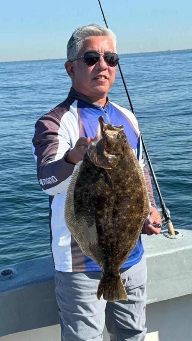 Jay San Agustin catches a fluke, known to be a delicious fish. Courtesy: Jay San Agustin via The FilAm 