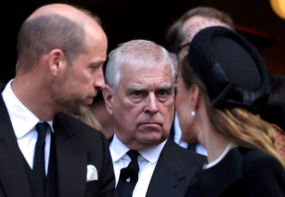 Britain's Prince Andrew stands next to Prince William and his wife Catherine, Princess of Wales