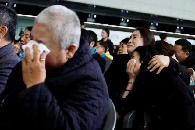 Bereaved family members react during a memorial ceremony marking the first anniversary of the Jeju Air crash, which claimed 179 lives, at Muan International Airport in Muan, South Korea, December 29, 2025. REUTERS/ Kim Soo-hyeon