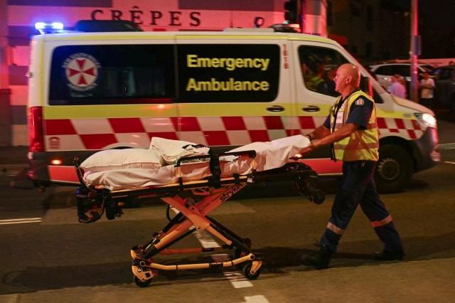 A health worker moves a stretcher after a shooting incident at Bondi Beach in Sydney on December 14, 2025. Saeed Khan/ AFP