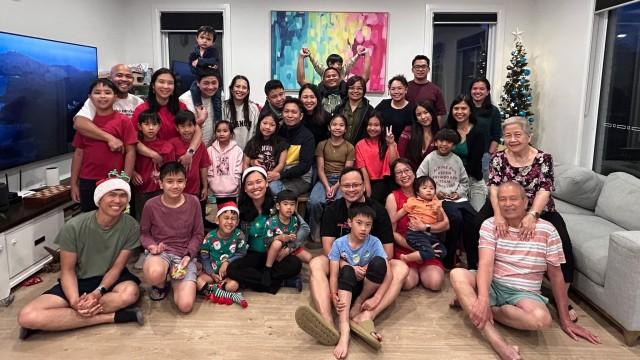 Francis and Abi Sevilla (front row, sixth and eighth from left) and their children at their home in Melbourne during an early Christmas celebration with friends on Saturday, December 20, 2025. JASON CANETA