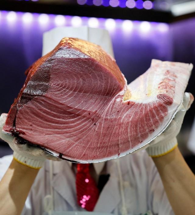 Above and below: Staff members of Kiyomura Co., which runs the Sushi Zanmai chain of sushi restaurants, pose with meat from the 243-kilogram bluefin tuna auctioned for a record 510 million yen, after cutting the tuna at the sushi restaurant in Tokyo, Japan, January 5, 2026. REUTERS/ Kim Kyung-Hoon