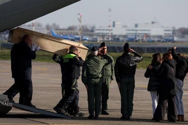 A coffin of a victim of a New Year's Eve fire and explosion in Crans-Montana is carried out of a military aircraft, at Milan's Linate Airport, Italy, January 5, 2026. REUTERS/ Claudia Greco