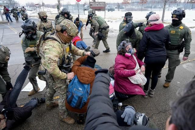 Demonstrators are detained at a protest against the fatal shooting of Renee Nicole Good by a US Immigration and Customs Enforcement (ICE) agent, during a rally against increased immigration enforcement across the city outside the Whipple Building in Minneapolis, Minnesota, January 8, 2026. REUTERS/ Tim Evans