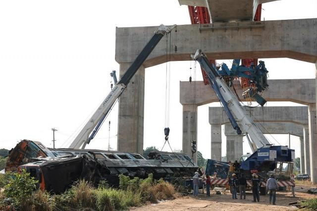 Officials work at the site where a train was derailed when a construction crane collapsed and fell onto its carriages, causing several casualties, in Sikhio district, Nakhon Ratchasima province, Thailand, January 14, 2026. REUTERS/ Chalinee Thirasupa