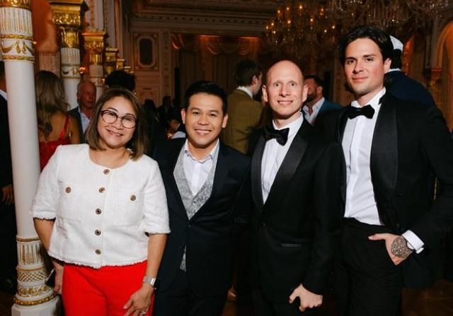 Pomoy with a female relative and members of his management team led by Roland Horvath and Valentin Lepsis. Courtesy: Munoz Photography via The FilAm
