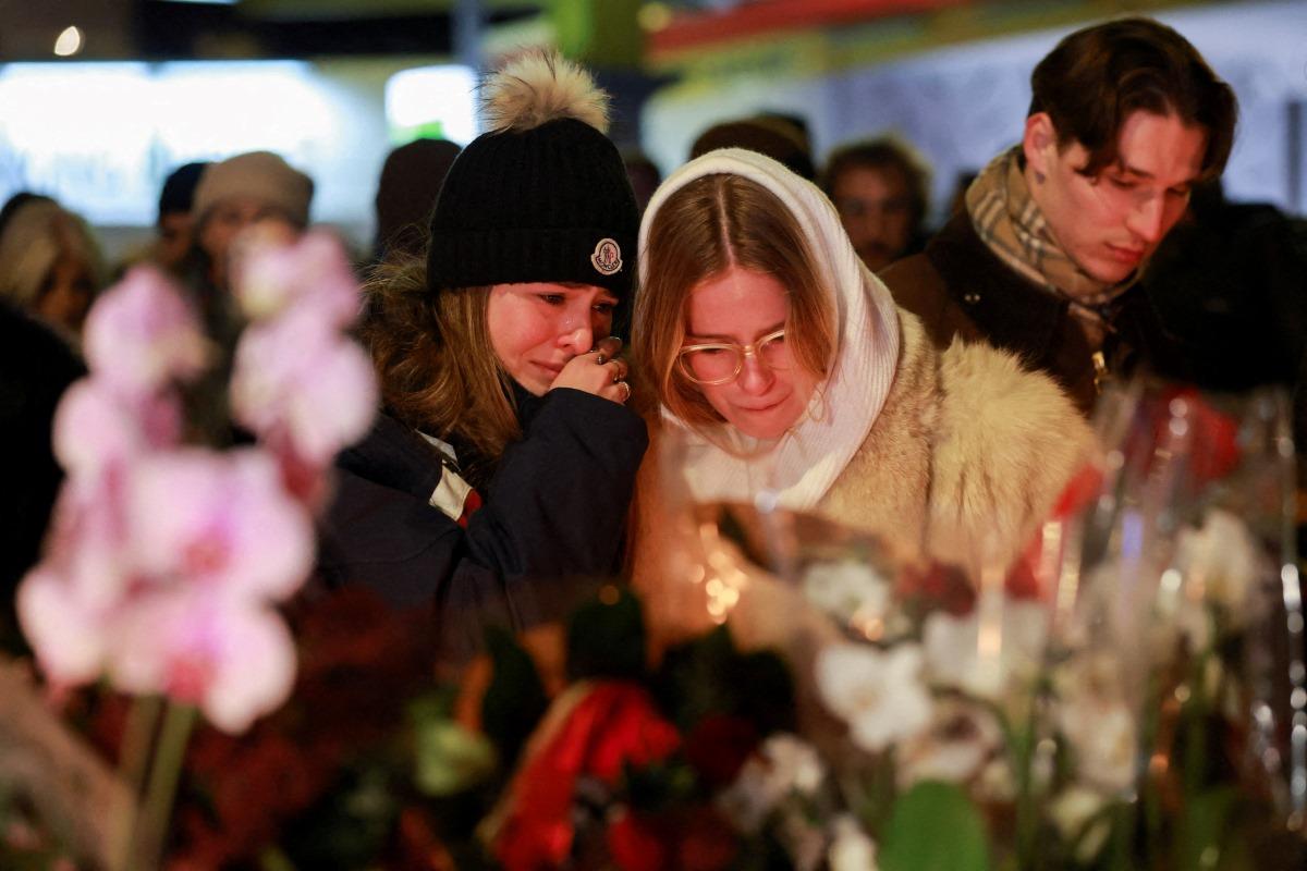 Tears and stunned silence at vigil for Swiss fire victims