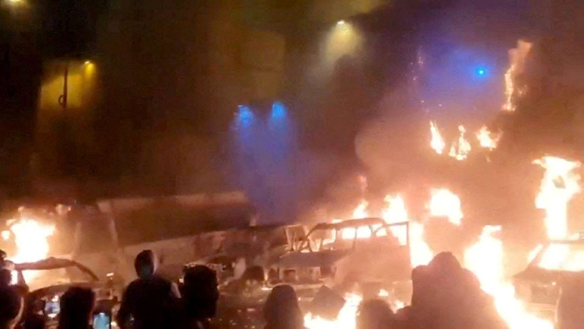 Protesters gather as vehicles burn, amid evolving anti-government unrest, in Tehran, Iran