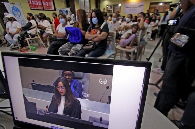 Families of victims killed during Duterte's drug war watch a live stream of the confirmation of charges against former President Rodrigo Duterte at the ICC, at the Arnold Janssen Kalinga Foundation in Tayuman, Manila, on Monday, February 23, 2026. DANNY PATA