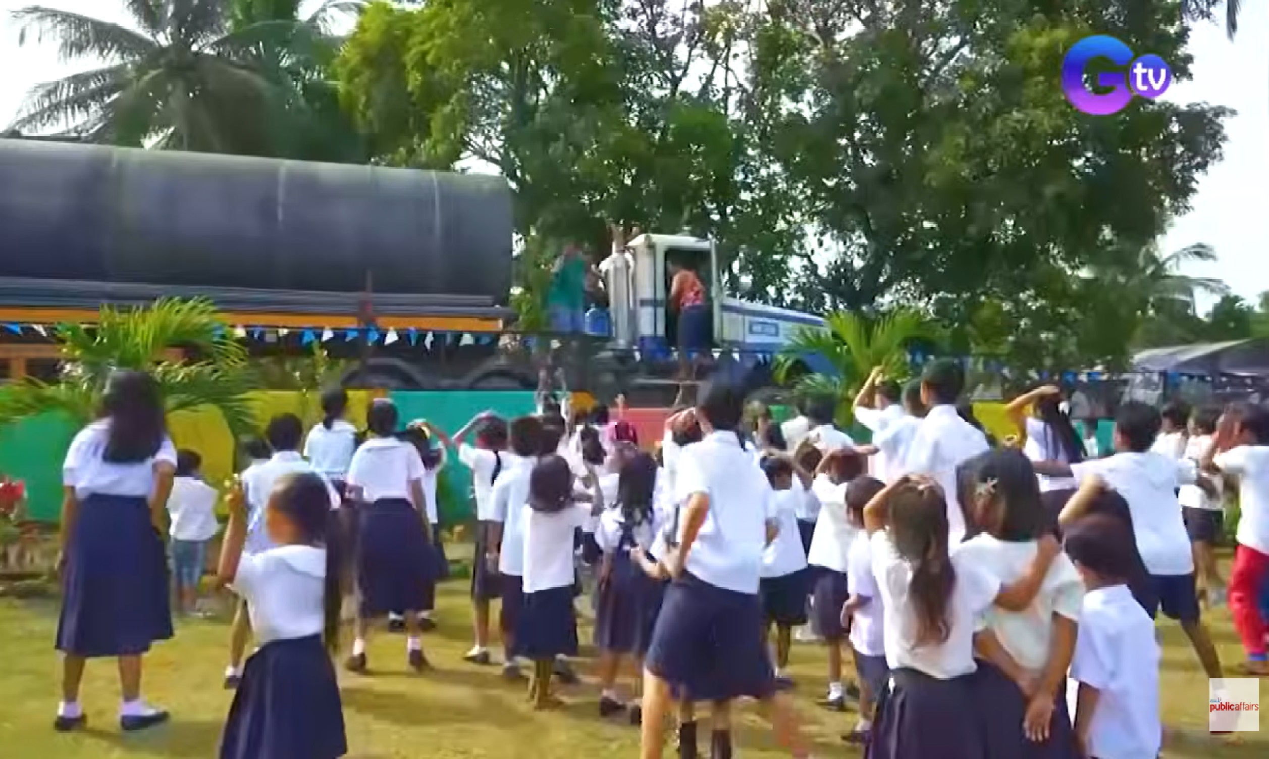 Driver at pahinante ng truck, nagbibigay ng saya sa mga batang estudyante 