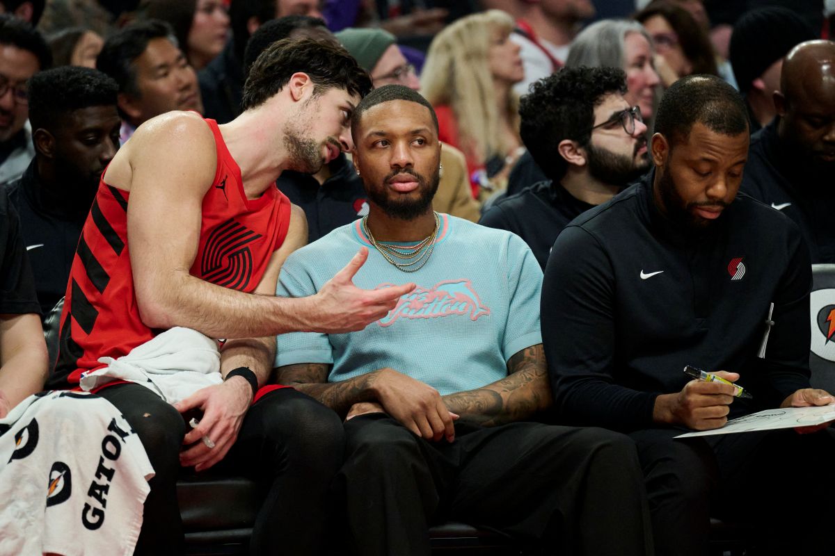 Portland Trail Blazers forward Deni Avdija talks to guard Damian Lillard