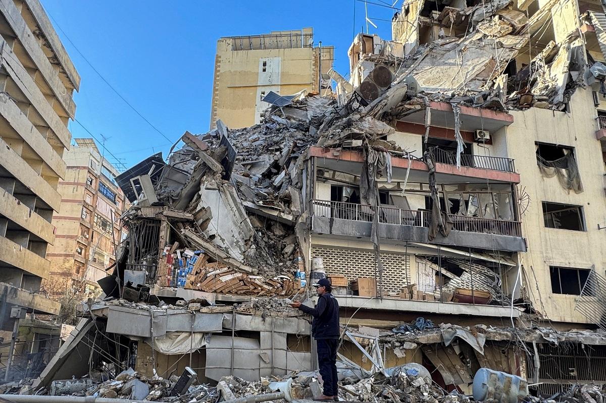 A man stands near a damaged building after Israeli strikes on Beirut. REUTERS/ Ahmad Al Kerdi