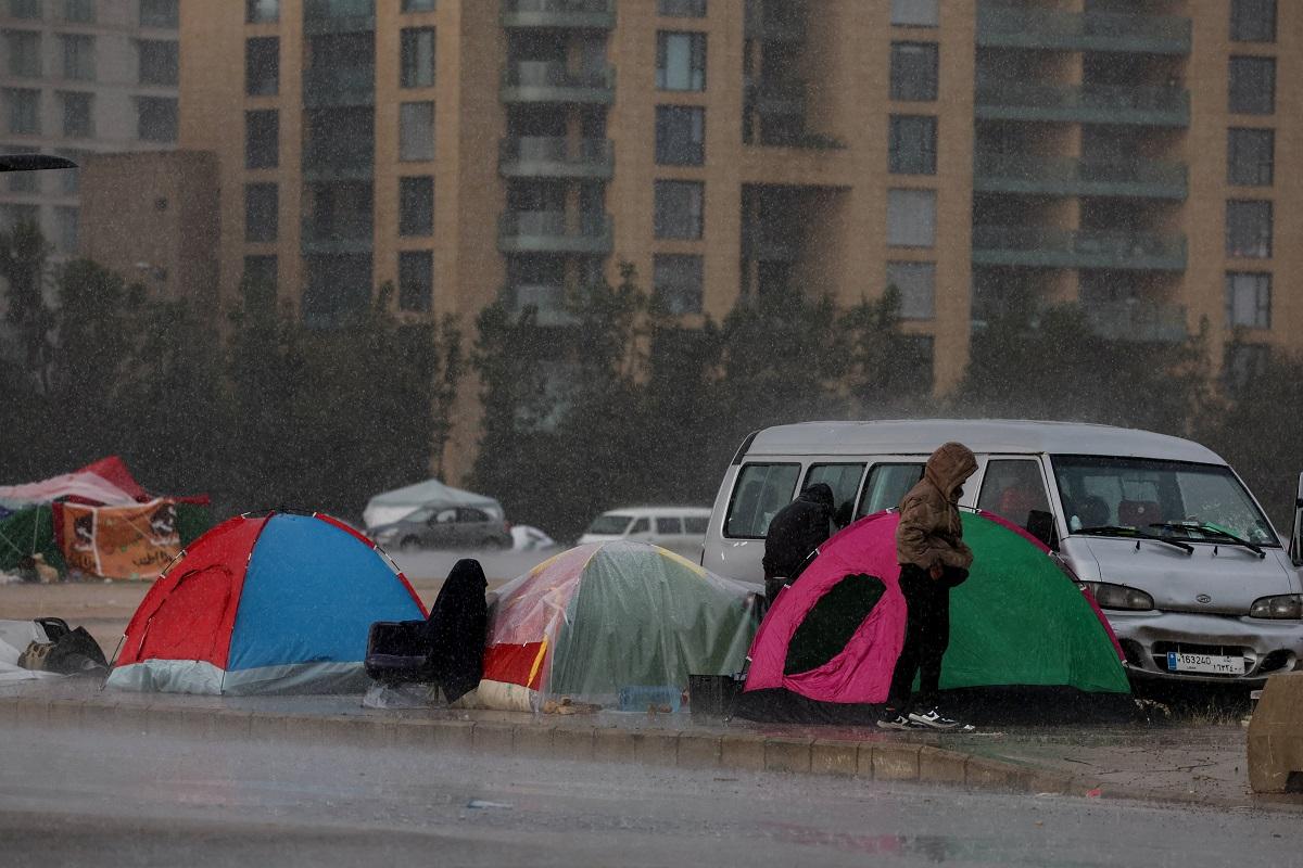 In heavy rain, Lebanese fleeing war huddle under makeshift shelters