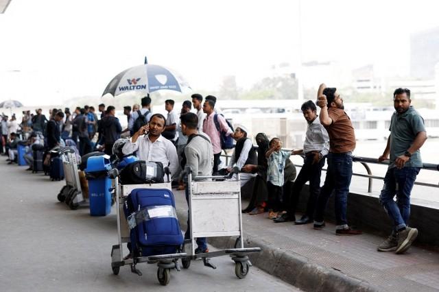 Stranded passengers wait at Hazrat Shahjalal International Airport after flights to Dubai and Bahrain were cancelled after Iranian strikes, following strikes on Iran launched by the United States and Israel, in Dhaka, Bangladesh, March 1, 2026. REUTERS/ Mohammad Ponir Hossain