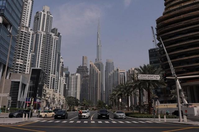 Vehicles wait at a traffic signal with the Burj Khalifa in the background, after an Iranian attack, following US and Israel strikes on Iran, in Dubai, United Arab Emirates, March 1, 2026. REUTERS/ Amr Alfiky