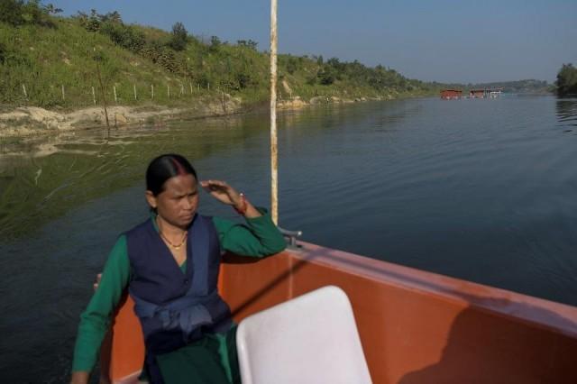 Anjani Singh, 30, drives a boat during a ride at Kenapara Eco Park. REUTERS/Avijit Ghosh