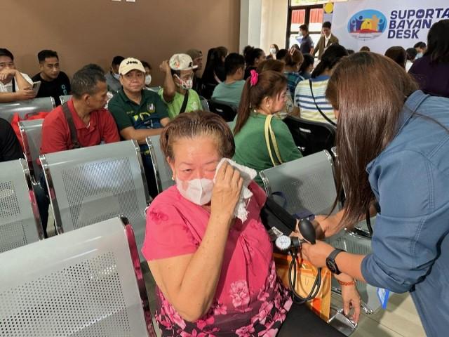 A tearful Norma Mahilum has her blood pressure taken by Suporta sa Bayan personnel at the House of Representatives on Thursday, March 26, 2026. Tina Panganiban-Perez/GMA Integrated News