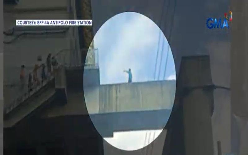 BFP personnel rescue man atop LRT-2 Antipolo station concrete beam