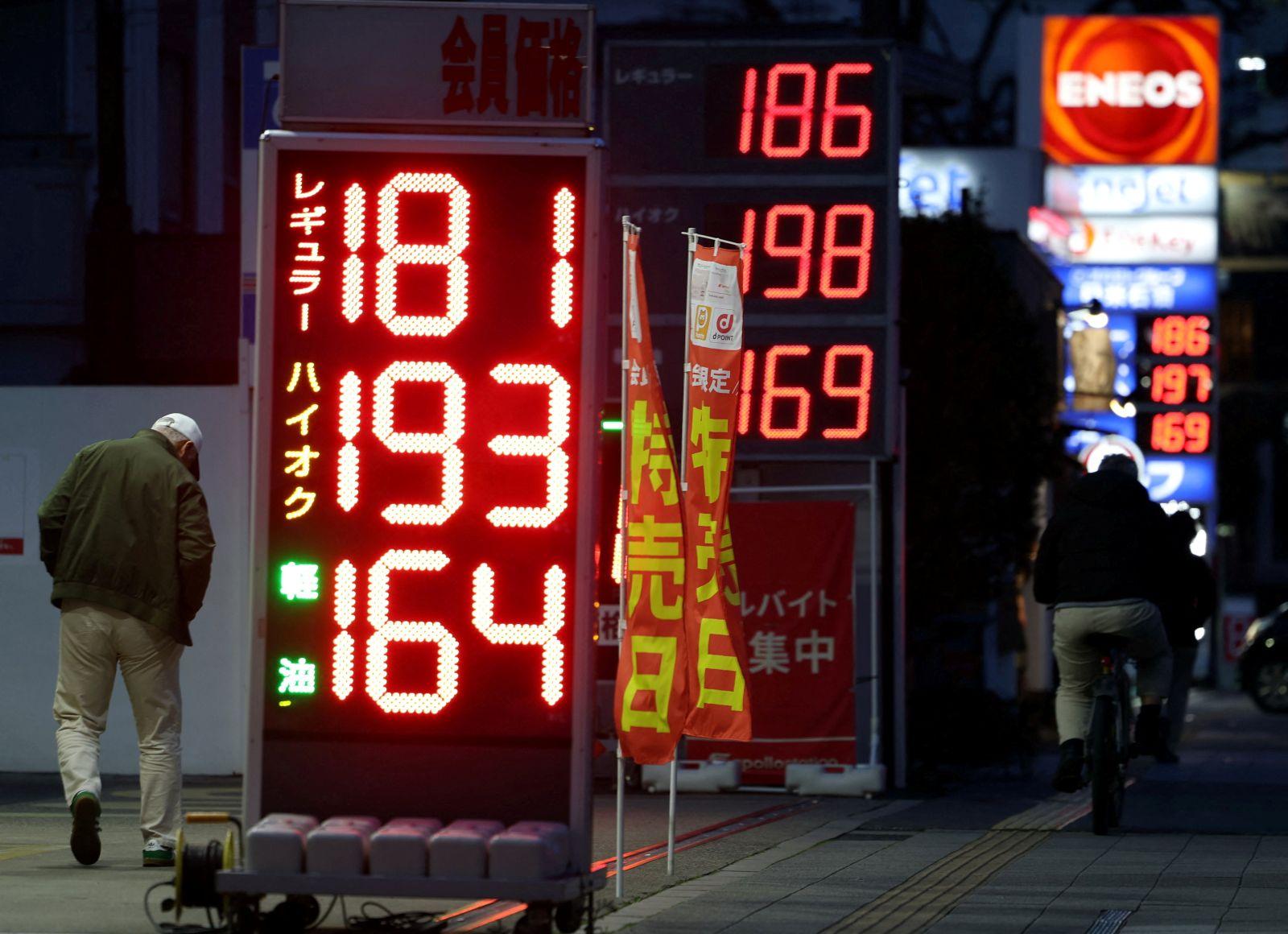Signboards display fuel prices outside gas stations in Tokyo | Photos ...