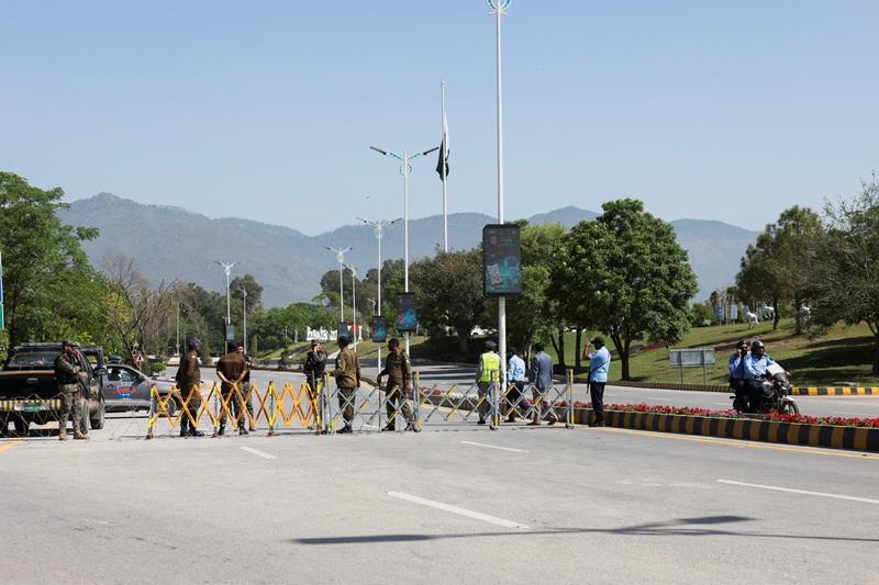 Police officers set up a roadblock for security measures near Serena Hotel