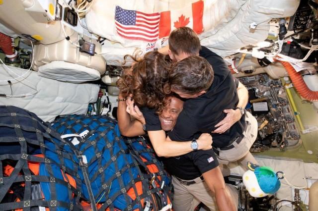 The NASA Artemis II crew, Mission Specialist Christina Koch, Mission Specialist Jeremy Hansen, Commander Reid Wiseman, and Pilot Victor Glover, embrace inside the Orion spacecraft on their way home following a flyby of the far side of the Moon on April 7, 2026. NASA/Handout via REUTERS 