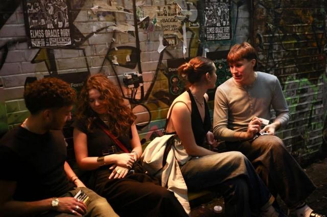 People gather in the smoking area outside The Carpet Shop nightclub in Peckham in London, Britain, November 15, 2025. REUTERS/Jack Taylor