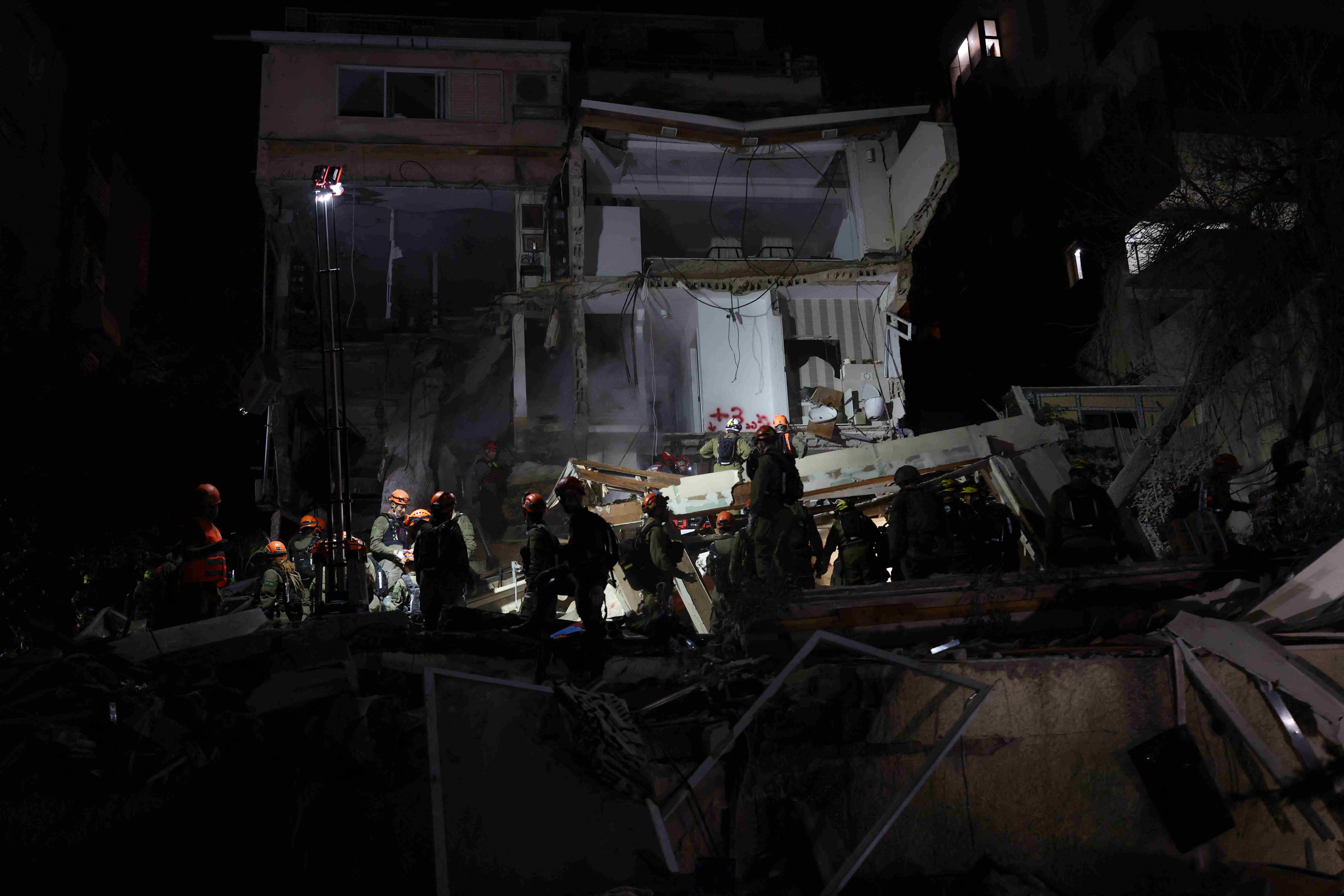 Israeli rescuers search for missing people after building hit by Iran missile