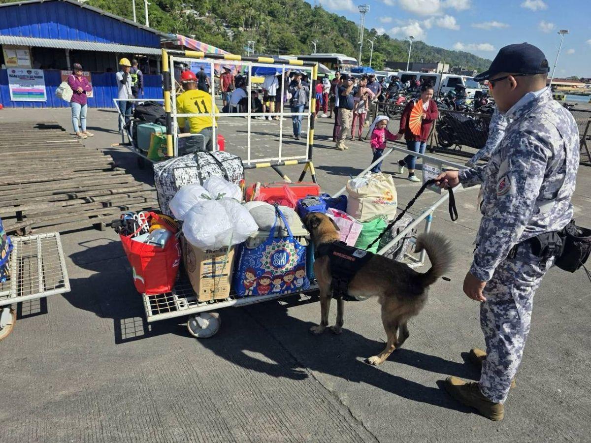 PCG K9 inspects luggage of passengers at Pasacao Port, Camarines Sur