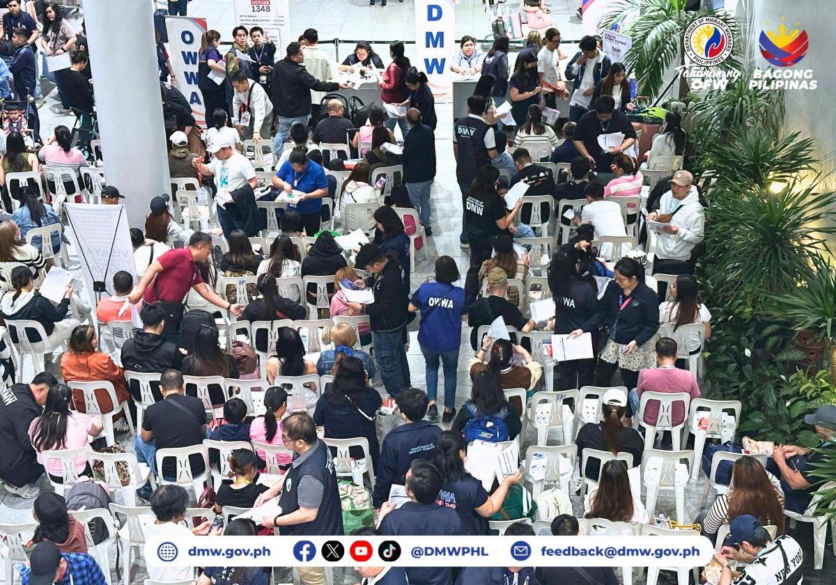 Department of Migrant Workers personnel assist repatriated OFWs