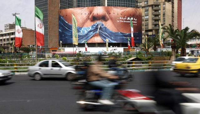 People drive past a billboard depicting US President Donald Trump and the Strait of Hormuz, in Tehran, Iran, May 2, 2026. Majid Asgaripour/ WANA (West Asia News Agency) via REUTERS