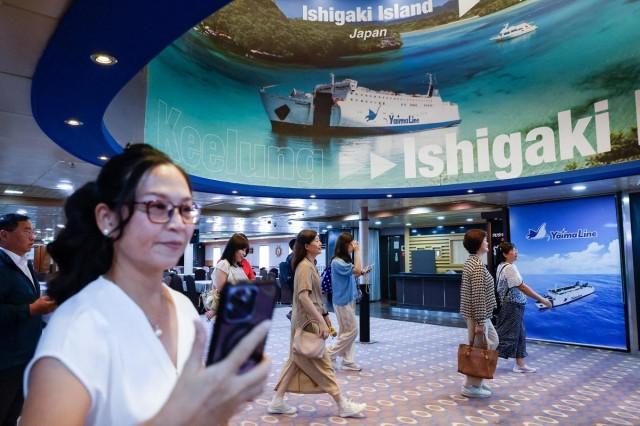 Government officials and members of the media attend a preview tour of the Yaima Maru ferry, which is set to operate between Taiwan and Japan's Ishigaki Island in Okinawa Prefecture, at Keelung, Taiwan, May 28, 2026. REUTERS/ Ann Wang